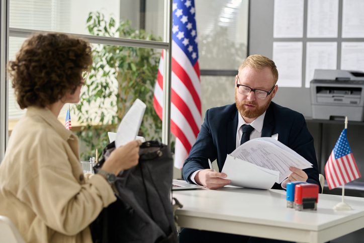 Young woman applying for visa in US immigration office